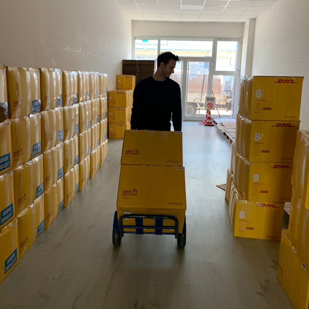 Ugur, co-founder of Wetcat, is carrying DHL boxes with a dolly