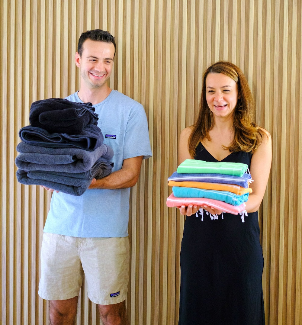Bediz and Ugur's picture where Ugur holds a big pile of 4 regular towels and Bediz holds a much more compact pile of Wetcat Turkish towels